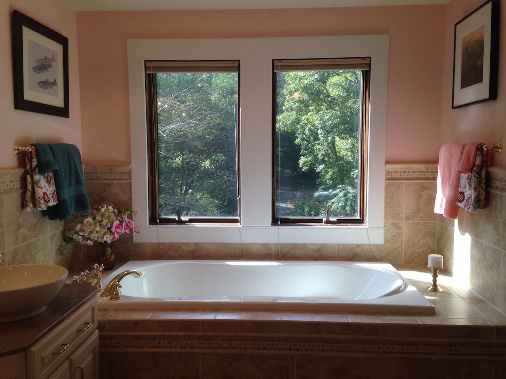 Soaking tub by the windows in the suite bath